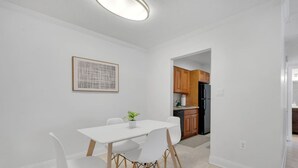 A modern kitchen with wooden cabinets and a black refrigerator. - Palma Ceia Retreat | Pool, Gym & Free Parking (Tampa)