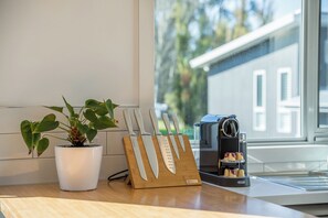A kitchen counter with a knife block, a coffee machine, and a potted plant. - Invermay Escape Stay Close to Stadium and Museums (Invermay)