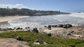A coastal beach with rocky terrain and waves.