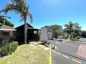 A gated entrance with a sign indicating a manager's office and parking.