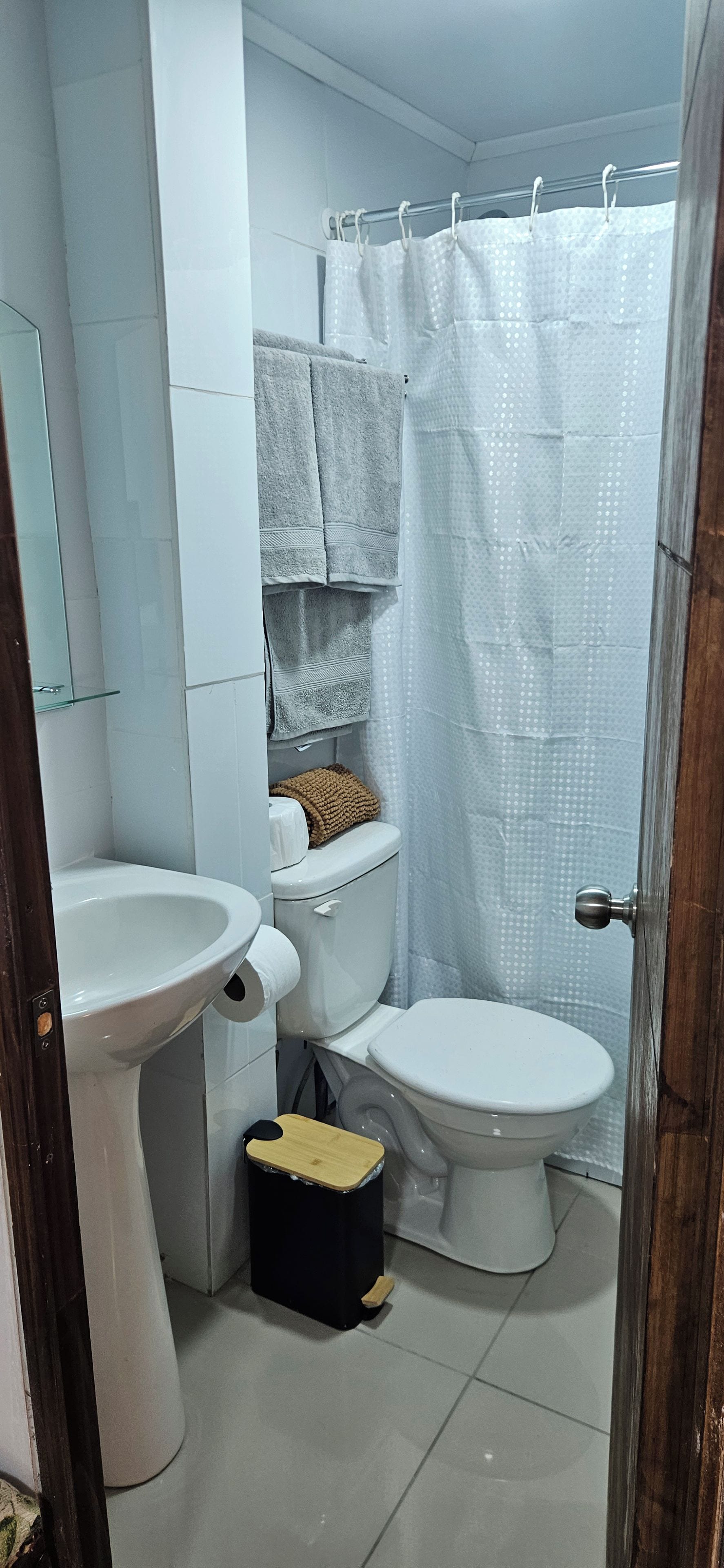 A bathroom with a toilet, bidet, and a sink.
