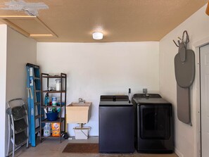 A compact kitchen with a refrigerator, a microwave, and a sink. - The Cape Escape | Cape Coral (Cape Coral)