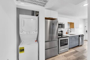 A modern kitchen with stainless steel appliances, including a refrigerator, oven, and microwave. - Comfy 1BR l Sleeps 4 l Near DT w/ Free Parking (Dallas)