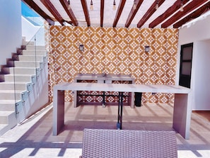 A modern outdoor seating area with a patterned wall, a staircase, and a view of the sky. - On 5TH AVE! Studio OCEAN VIEW balcony & pool (Playa del Carmen)