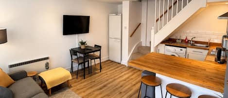 A modern apartment with a living room, kitchen, and dining area.
