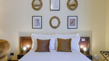 A hotel room with a bed, two nightstands, a chair, and wall-mounted mirrors and artwork.