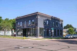 A two-story building with large windows and a brick facade.