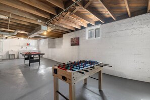 A room with a foosball table, a pool table, and a kitchenette area. - Spacious 4BR • 5 Bds •2Bts Ranch for Mid Term Stay (Rockford)