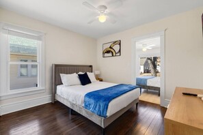 A bedroom with a bed, a ceiling fan, a window, and a door leading to another room. - Spacious 4BR • 5 Bds •2Bts Ranch for Mid Term Stay (Rockford)