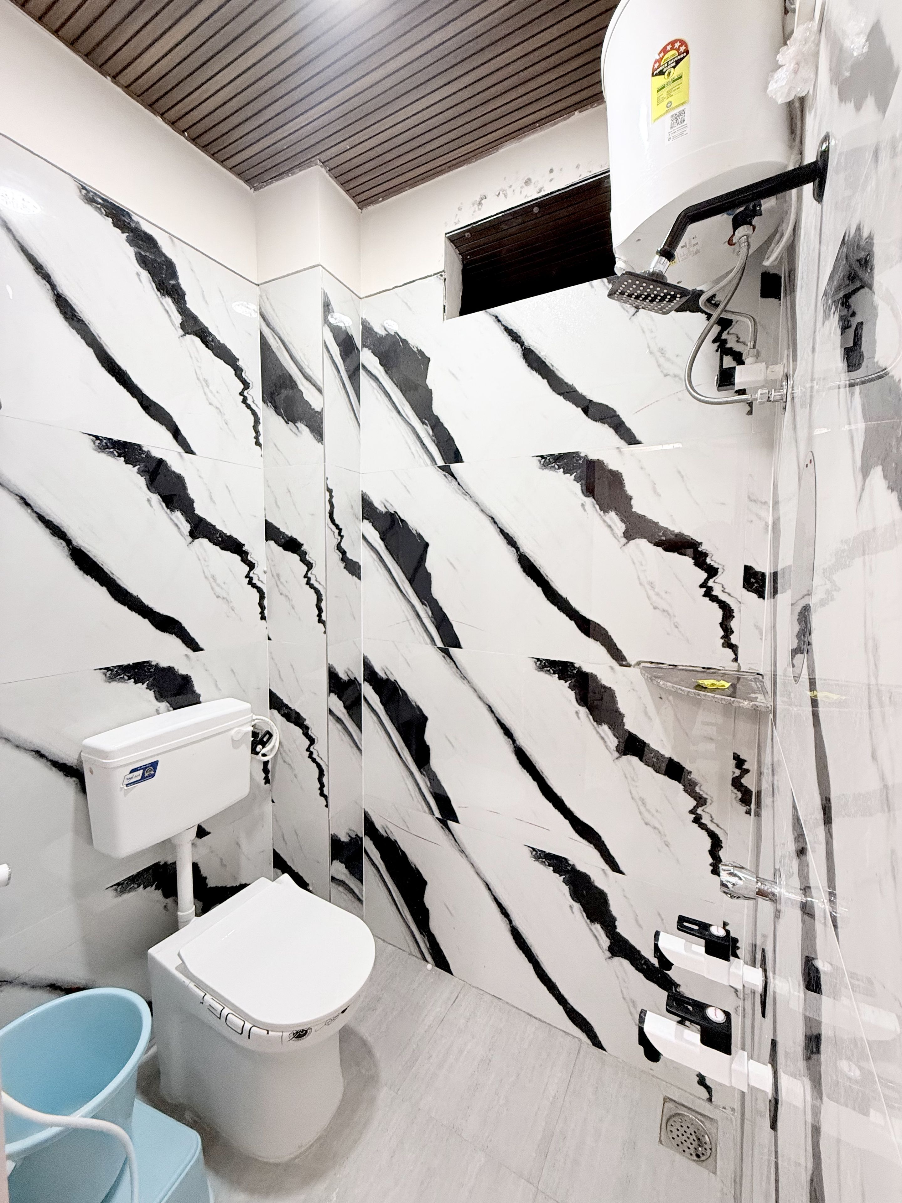 A bathroom with a toilet, bidet, and a shower area.