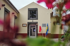 A building with a reception sign, a window, and two flags.