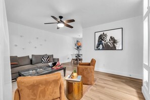 A modern living room with a sofa, two armchairs, a coffee table, and a ceiling fan. - Tropical Oasis - 3BR, 10 Min Bal Harbour- Parking (Biscayne Park)
