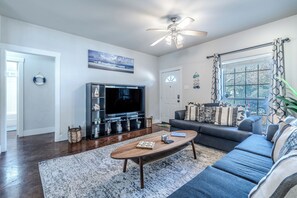 A living room with a television, sofa, coffee table, and a ceiling fan. - Spacious 3BR Downstairs Home Near TCU - Fort Worth (Fort Worth)