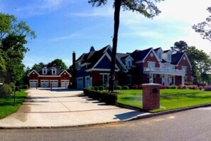 A suburban two-story house with a front driveway, a well-maintained lawn, and a brick mailbox. - Luxury Estate on Green w pool, gym & theatre (Middle Township)