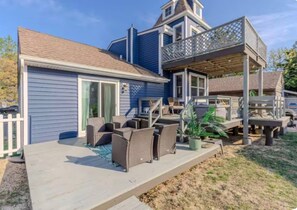 A residential deck with outdoor furniture, a covered area, and a staircase leading to a second level. - Bleu Bay Cottage•Steps to Beach•Sleeps 8•Bay Views (Lower Township)
