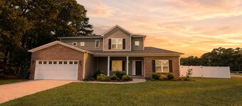 4BR Home Elevated Stay + 100" TV Media Room Near Cape Fear Hospital & Fort Bragg