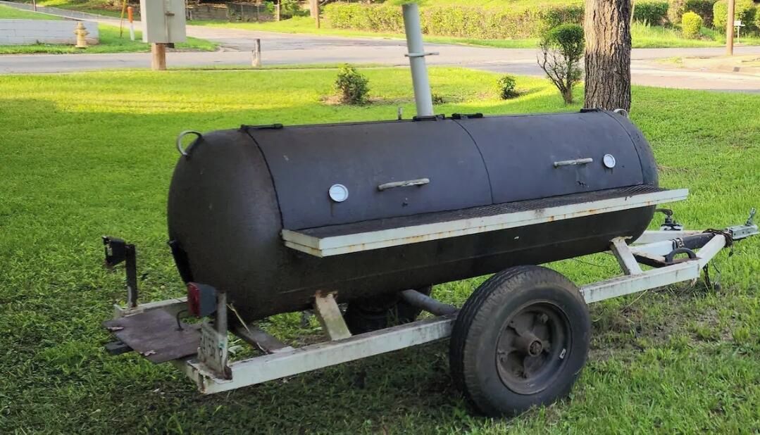 A portable barbecue grill on a trailer.