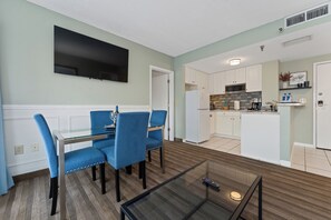 A modern kitchen with white cabinets, a microwave, and a coffee maker. - Tranquil 2Bed/2Bath with Balcony Near Universal (Orlando)