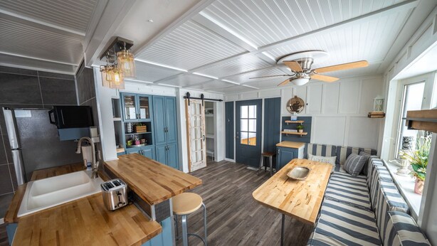 A modern kitchen with a wooden countertop, a built-in sink, and a ceiling fan. - Duluth Charmer - 3B/2B cozy home (Sioux Falls)