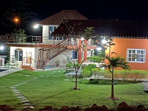 A two-story building with a staircase leading to the upper floor, a well-maintained lawn, and a small palm tree. - Private Oasis Villa: Pool, BBQ Area & Lush Nature - Family Friendly (Provincia de Panamá Oeste, Corregimiento de Guayabito)