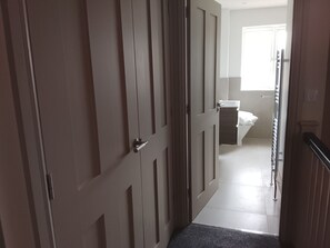 A hallway leading to a bathroom with a toilet and a sink. - Village House with open countyside views close by the bustling 'Norton Dog ' pub (Norton)