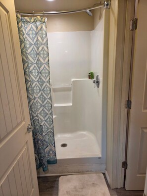 Un baño con ducha, inodoro y lavamanos.