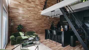 A modern interior with a wooden wall, a staircase, a dining area, and a seating arrangement.
