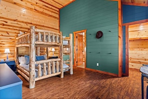 A log cabin interior with a bunk bed, a desk, and a green wall. - 6 En-Suite Bedrooms, Indoor Pool, Theater, Hot Tub, Epic Mountain Views (Sevierville)