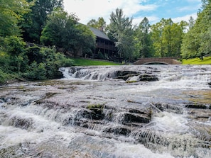 A waterfall with a wooden structure in the background. - 6 En-Suite Bedrooms, Indoor Pool, Theater, Hot Tub, Epic Mountain Views (Sevierville)