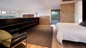 A modern bedroom with a bed, a bench, a rug, and a view of the outdoors. - Interlude, sleek modern retreat with hot tub (Daylesford)