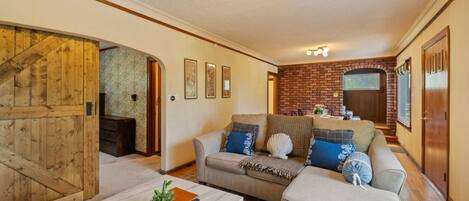A living room with a sofa, coffee table, and a fireplace.