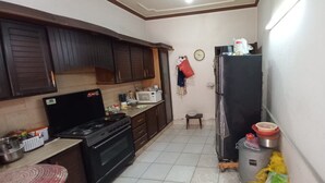Eine kleine Küche mit Herd, Mikrowelle und Kühlschrank.
