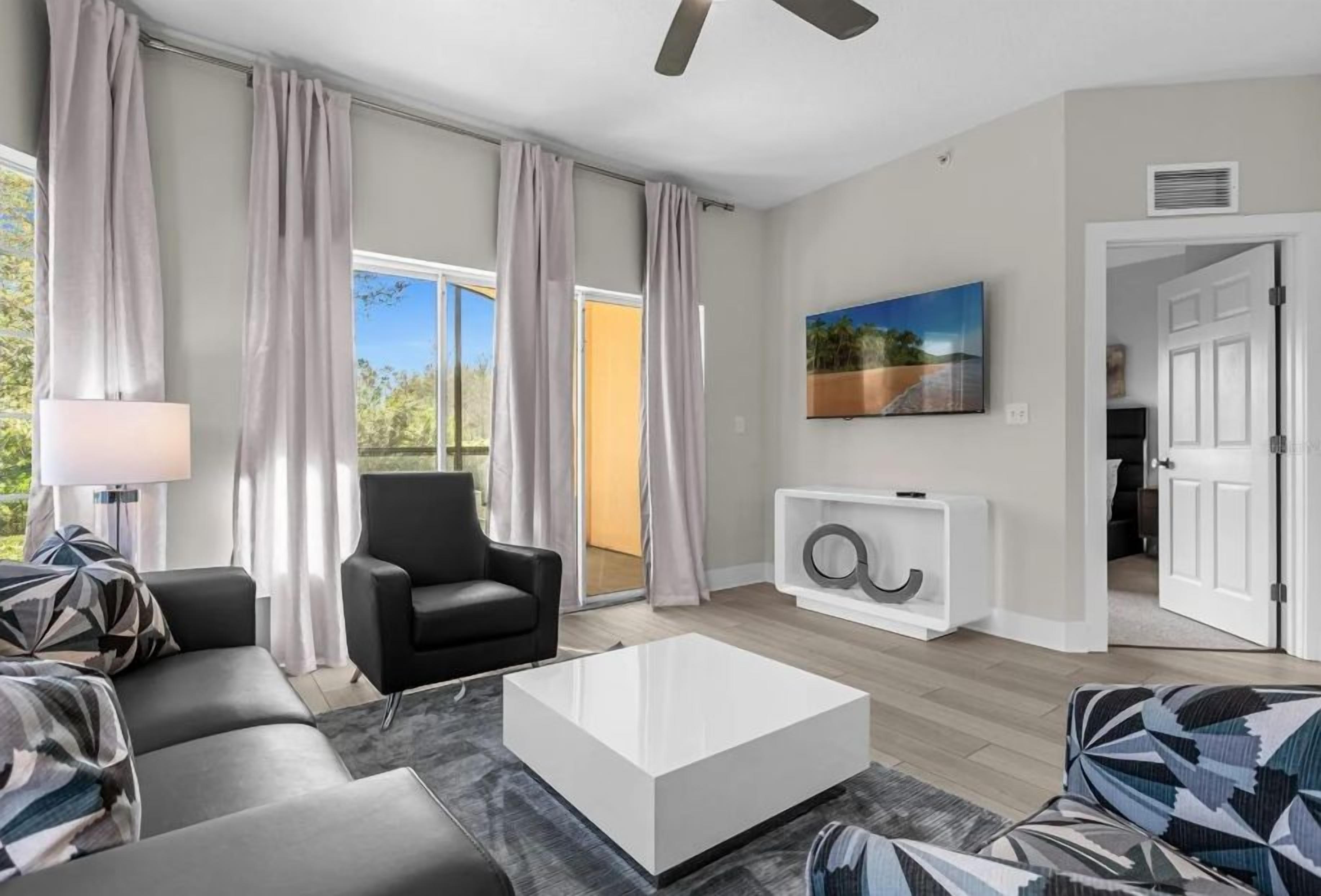 A modern living room with a sofa, armchair, and coffee table.