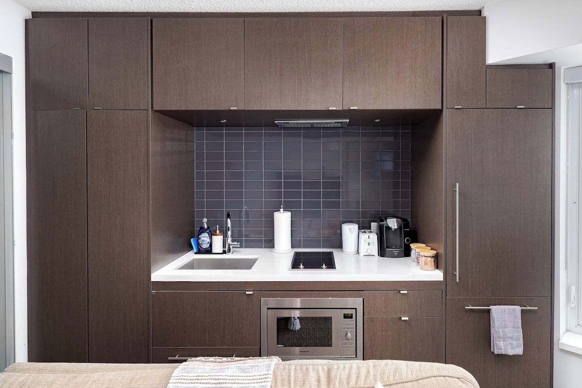 A compact kitchen with a microwave, toaster, and coffee maker.