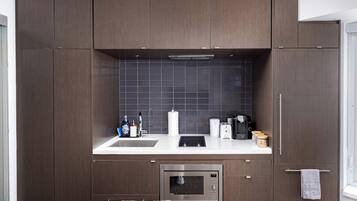 A compact kitchen with a microwave, toaster, and coffee maker.