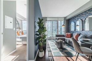 Un salon moderne avec un canapé, une table basse et une grande fenêtre.