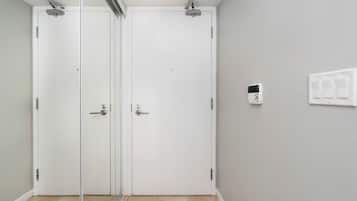 A room with a sliding door, a light switch, and a power outlet on the wall.