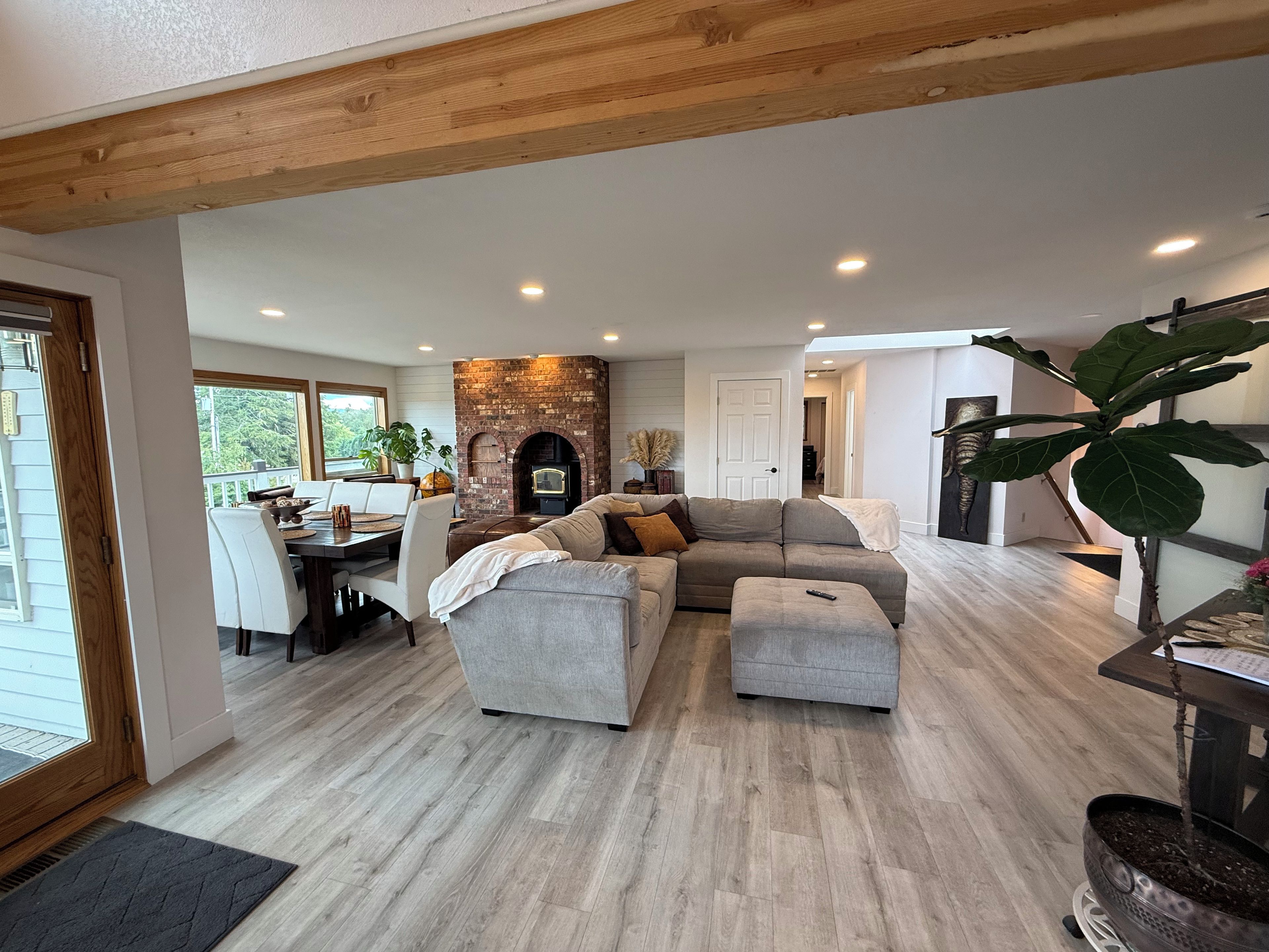 A spacious living area with a fireplace, a dining table, and a comfortable seating arrangement.