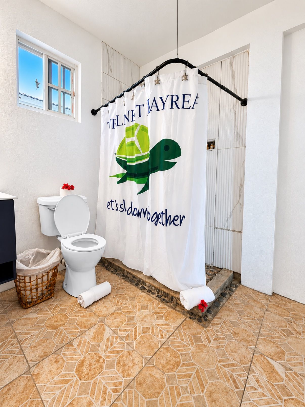 A bathroom with a shower curtain featuring a green turtle and the text 'it's down to together.'