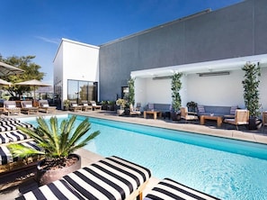A modern pool area with lounge chairs and a large pool. - The Icon' Full Hollywood Sign View Rooftop Pool (Los Angeles)