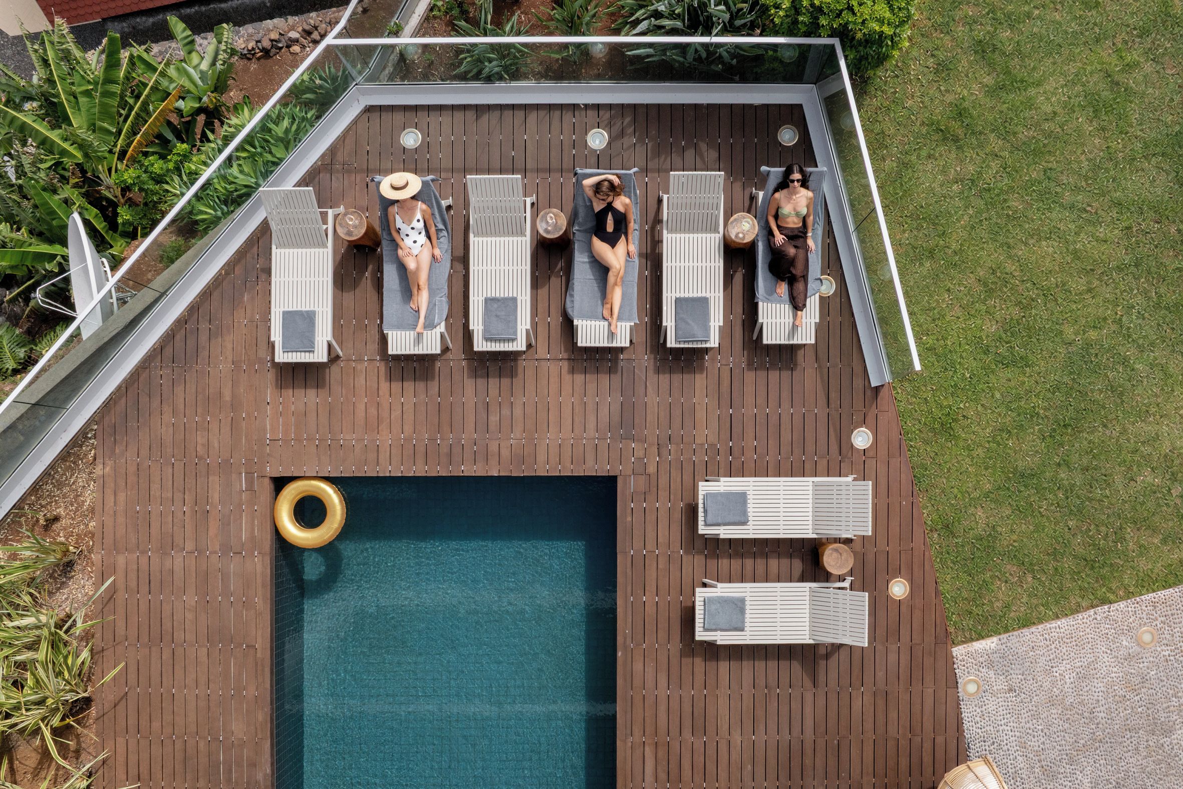 A rooftop pool area with lounge chairs and a small pool.