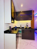 Una cocina moderna con estufa integrada, un fregadero y un microondas.