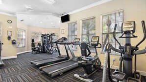 A gym with treadmills, elliptical machines, and weight equipment. - 3BR Resort Condo Windsor Palms Near Disney (Kissimmee)