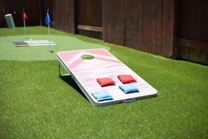 A pool table with a wooden frame, a green felt surface, and three cushions in red, blue, and blue colors. - *NEW* 6BR, 4 Kings, MovieRoom, BilliardS, MiniGolf (Katy)