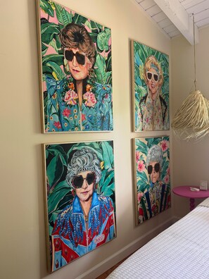 A wall with four framed paintings of individuals in tropical attire. - KeyLime Oasis - Private Pool, 3 Beds, 2 Baths, with Boat Parking (Tavernier)