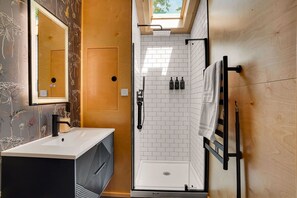 A modern bathroom with a shower, a sink, and a mirror. - Juniata River Escape (McVeytown)