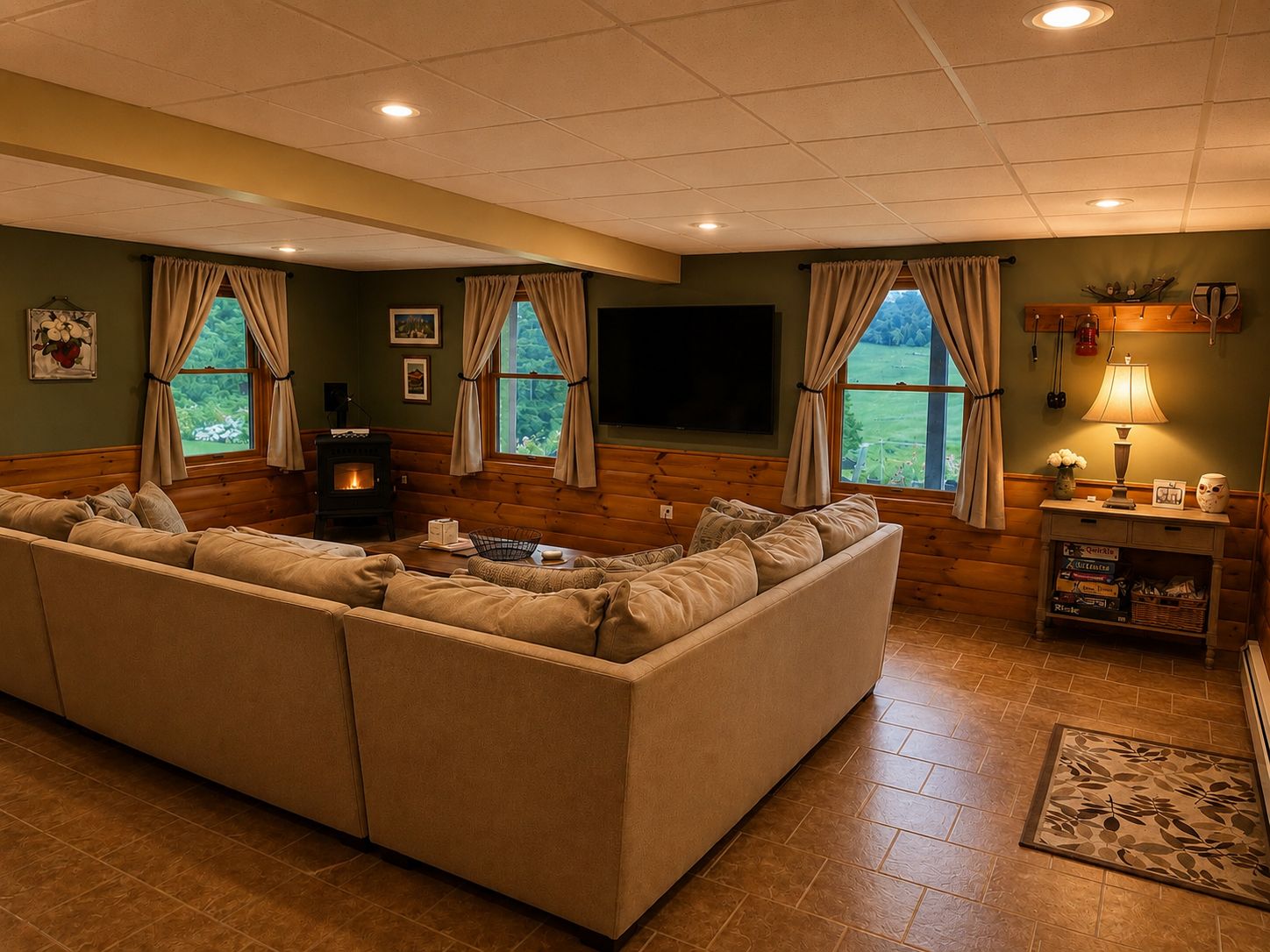 A cozy living room with a sectional sofa, a fireplace, and a view of the outdoors.