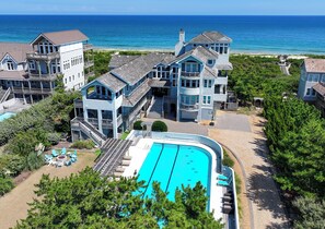 A beachfront property with a swimming pool, multiple balconies, and a view of the ocean. - OCEANFRONT, Ocean & Sound Views, Priv Pool, SAUNA-PM3, Palmers View (Duck)