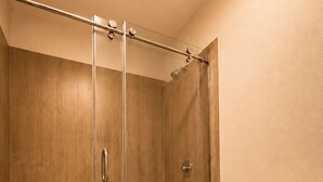 A bathroom with a glass-enclosed shower, a toilet, and wooden flooring. - 8 mins to Disney Resort Style Living with Pool (Kissimmee)