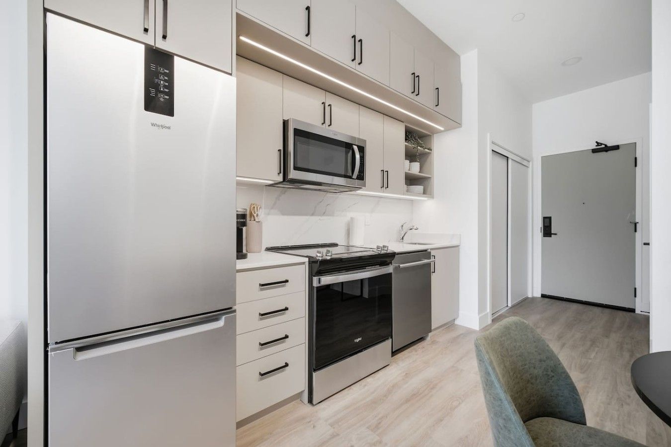 A modern kitchen with a built-in microwave, oven, and refrigerator.